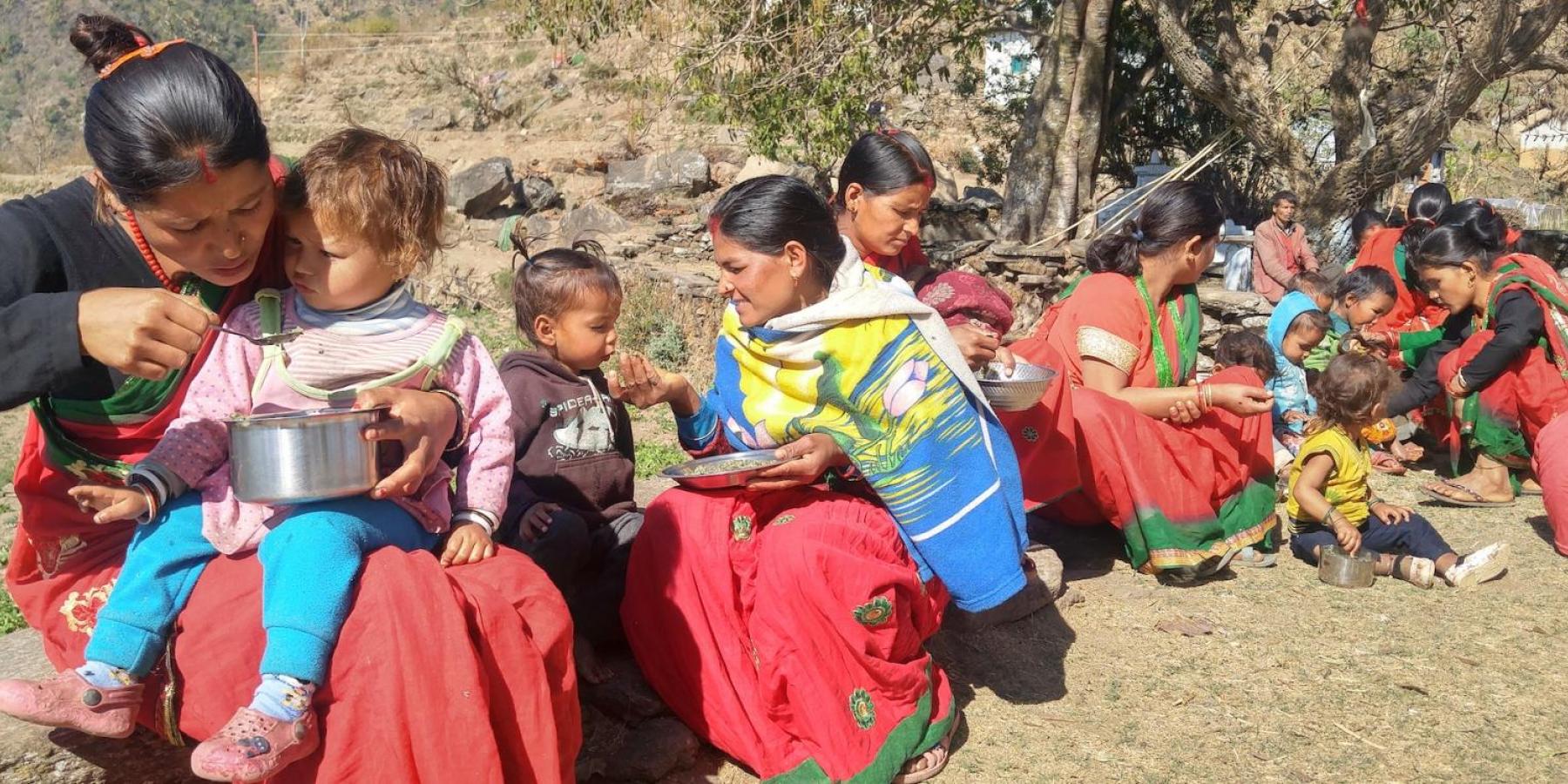 Achham mothers feeding children